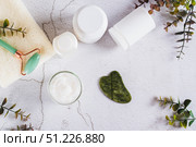 Beef tallow for skin care in a jar and massagers on the table top view. Стоковое фото, фотограф Елена Руй / Фотобанк Лори