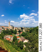 Kutna Hora, Czech Republic, July 23, 2018: view of town. Old town, cityscape, lush greenery and bright blue sky. Aerial view on many red roofs. Редакционное фото, фотограф Olga Monako / Фотобанк Лори