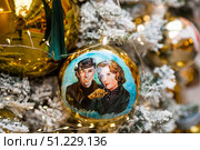 A decorated Christmas tree of the Mosfilm film company with portraits of actors from popular Soviet films, in the GUM store in the center of Moscow. Russia, Moscow, January 9, 2025. Редакционное фото, фотограф Photojuli / Фотобанк Лори