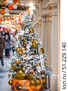 A decorated Christmas tree of the Mosfilm film company with portraits of actors from popular Soviet films, in the GUM store in the center of Moscow. Russia, Moscow, January 9, 2025. Редакционное фото, фотограф Photojuli / Фотобанк Лори