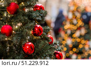 Holiday toys on the Christmas tree. Beautiful Christmas background. Concept of preparing decorations and furnishings for the New Year 2026. Стоковое фото, фотограф Photojuli / Фотобанк Лори