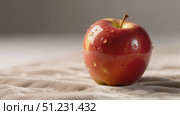 Свежее красное яблоко с каплями воды на светлом фоне с кописпейсом / Fresh red apple with drops of water on a light background with a copy space. Стоковое AI-изображение, AI-художник Валерий Лукин / Фотобанк Лори
