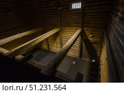Yuryevets, Ivanovo region, Russia, July 24, 2025: Interior old wooden merchant's storehouse of Katyushin estate from 19th century, now modern exhibition space. Редакционное фото, фотограф Алексей Антипов / Фотобанк Лори