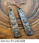 Rustic Silver Celestial Pattern Earrings With Stars and Sun. Generative AI. Стоковое AI-изображение, AI-художник Roman Zavorotny / Фотобанк Лори