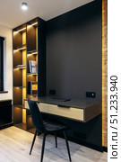 Contemporary and Stylish Modern Home Office Design Featuring an Elegant Desk and Open Shelving. Стоковое фото, фотограф Cantemir Dumitru / Фотобанк Лори