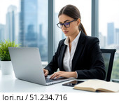 Woman working on laptop in office near window with view of city skyscrapers. Стоковое AI-изображение, AI-художник Ирина Самойлова / Фотобанк Лори