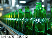 Beer Bottling plant. Green Beer Bottles in rows. Bottling process in modern factory. Capped Glass Beer Bottles ready for distribution in a brewery. Manufacturing. Production of beer in a glass bottle. Стоковое AI-изображение, AI-художник Марина Демидюк / Фотобанк Лори