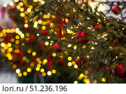 Holiday toys on the Christmas tree. Beautiful Christmas background. Concept of preparing decorations and furnishings for the New Year 2026. Стоковое фото, фотограф Photojuli / Фотобанк Лори