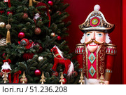 The Nutcracker on the New Year's tree in Moscow. New Year's card 2026. Beautiful Christmas background. Concept of preparing decorations and attire for the New Year. Стоковое фото, фотограф Photojuli / Фотобанк Лори