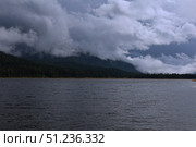 A Mysterious Lake Located Beneath Dark and Ominous Clouds. Стоковое фото, фотограф Igor Bastrakov / Фотобанк Лори