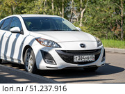 KRASNOYARSK, RUSSIA - August 19, 2025: White Mazda Axela. Редакционное фото, фотограф Плотников Дмитрий / Фотобанк Лори