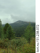 A Serene Mountain Landscape Set Beneath Cloudy Skies, Truly Majestic. Стоковое фото, фотограф Igor Bastrakov / Фотобанк Лори