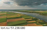 Aerial view of colorful fields on bank of Danube. Стоковое видео, видеограф Михаил Коханчиков / Фотобанк Лори