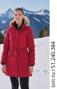 Young woman standing in red winter coat on snowy mountain landscape. Стоковое AI-видео, аниматор KATERINA AI / Фотобанк Лори