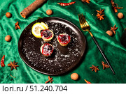 Crimson Desserts on Black Plate Dance Amidst Emerald Fabric and Autumn Spices. Стоковое фото, фотограф Aleksandr Golubev / Фотобанк Лори