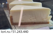 Indulge in these incredibly smooth and rich cheesecake slices, which are simply perfect for dessert lovers. Стоковое видео, видеограф worker / Фотобанк Лори