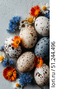 Colorful Speckled Eggs Surrounded by Vibrant Flowers on a Textured Surface During Springtime. Стоковое AI-изображение, AI-художник Юлия Гапеенко / Фотобанк Лори