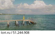 Woman in summer dress walks on old wooden pier above calm sea in Yucatan Mexico. Стоковое видео, видеограф Ольга Сухарева / Фотобанк Лори