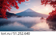 Mount fuji reflecting in lake with red autumn leaves and mist at sunrise. Стоковое фото, фотограф David Kashakhi / Фотобанк Лори