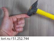 Different tools on a wooden background. The hammer struck one's finger. Стоковое фото, фотограф Арзюков Вадим Николаевич / Фотобанк Лори