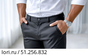 Close-up of formal attire showcasing a black dress shirt and slacks. Стоковое AI-изображение, AI-художник Katsiaryna Repich / Фотобанк Лори