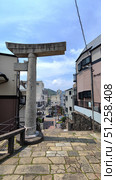 Nagasaki, Japan - May 12, 2025. One-legged Torii in middle of city. Стоковое фото, фотограф Константин Никитеев / Фотобанк Лори