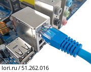 Сетевой кабель подключен к материнской плате компьютера. LAN cable is connected to the computer's motherboard. Стоковое фото, фотограф Татьяна Д / Фотобанк Лори