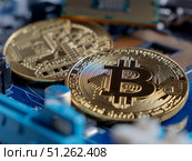Cryptocurrency Bitcoin Coins on Computer Circuit Board. Редакционное фото, фотограф Sergakoff / Фотобанк Лори