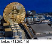 Bitcoin Cryptocurrency Coin on Computer Circuit Board. Редакционное фото, фотограф Sergakoff / Фотобанк Лори