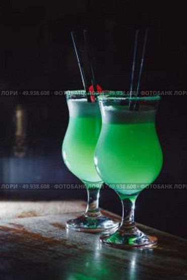 A beautiful green cocktail with white foam and cherry in a tall glass. close-up. Стоковое фото, агентство Ingram Publishing / Фотобанк Лори