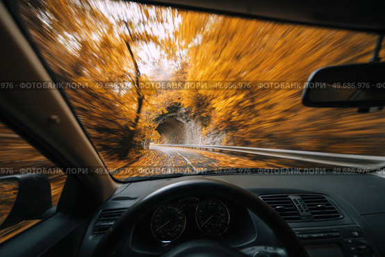 A car is driving down a road with a tunnel in the background. Стоковое AI-изображение, AI-художник Ярославский Максим / Фотобанк Лори