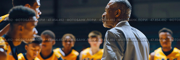A coach passionately encourages players during a timeout in a youth basketball tournament held in a gym. Стоковое AI-изображение, AI-художник Данила Большаков / Фотобанк Лори