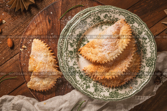 A crescent-shaped pastry whose filling is made of eggs and almonds wrapped in crispy dough, cut in an artisanal way and sprinkled with sugar. Стоковое фото, агентство Ingram Publishing / Фотобанк Лори