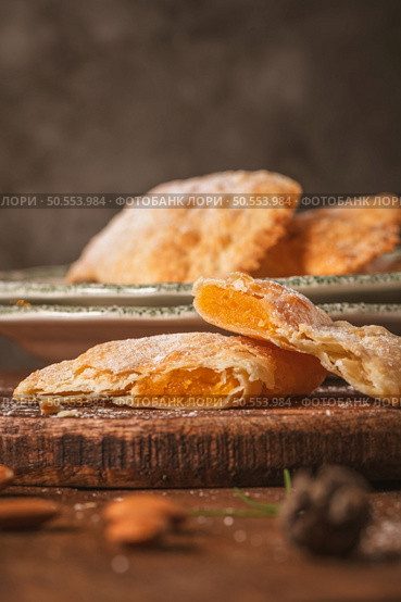 A crescent-shaped pastry whose filling is made of eggs and almonds wrapped in crispy dough, cut in an artisanal way and sprinkled with sugar. Стоковое фото, агентство Ingram Publishing / Фотобанк Лори