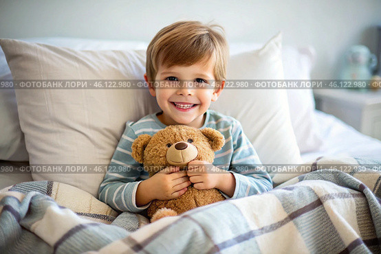 A cute boy hugs a teddy bear, sitting in a cozy bed, a small child hugs a toy and gets ready for bed. A healthy night's sleep. Стоковое AI-изображение, AI-художник Photojuli / Фотобанк Лори