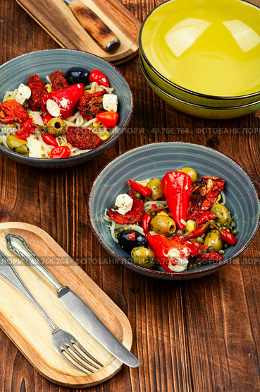 A delicious salad of pickled soybean sprouts, dried tomatoes, olives and peppers. Chinese food.. Vegan Salad of Pickled Vegetables and Soybeans. Стоковое фото, агентство Ingram Publishing / Фотобанк Лори