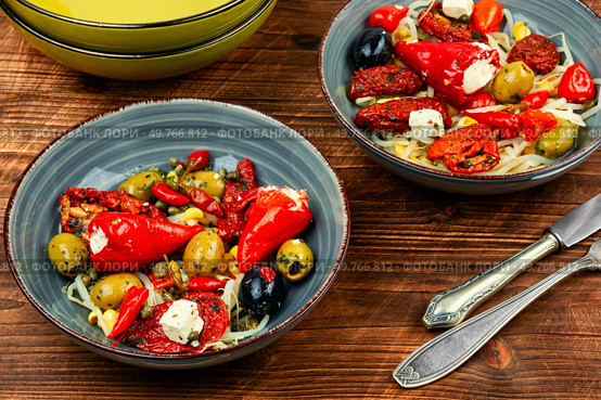 A delicious salad of pickled soybean sprouts, dried tomatoes, olives and peppers on rustic wooden table. Chinese food.. Vegan Salad of Pickled Vegetables and Soybeans. Стоковое фото, агентство Ingram Publishing / Фотобанк Лори