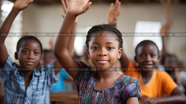 A group of African children raising their hands to answer questions in a lively and engaged classroom. Black African children from disadvantaged families study in school, read books, receive primary education, volunteer service. Стоковое AI-изображение, AI-художник ALLA YURTAYEVA / Фотобанк Лори