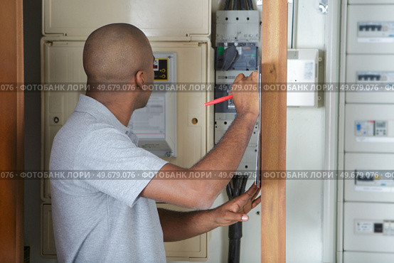 a lineman checking the panel. Стоковое фото, агентство Ingram Publishing / Фотобанк Лори