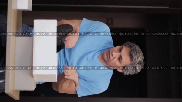 A man is dissatisfied with the purchase of shoes from the store. Bad product. Стоковое видео, видеограф Юрий Поздников / Фотобанк Лори