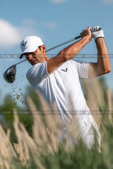 A man is swinging a golf club in a field of tall grass. Стоковое AI-изображение, AI-художник Ярославский Максим / Фотобанк Лори