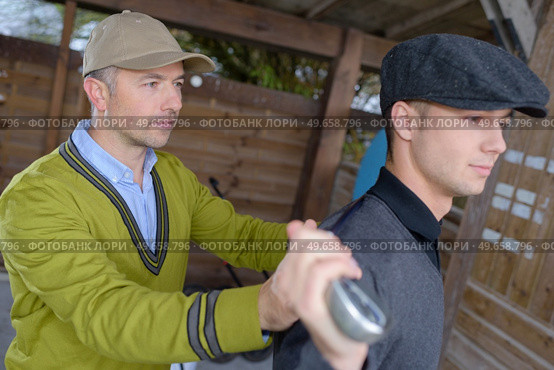 a man training young golfer. Стоковое фото, агентство Ingram Publishing / Фотобанк Лори