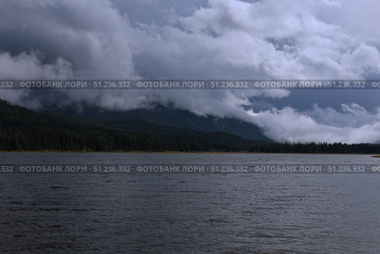 A Mysterious Lake Located Beneath Dark and Ominous Clouds. Стоковое фото, фотограф Igor Bastrakov / Фотобанк Лори