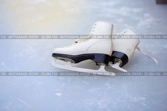 A pair of curly female skates lies on the ice at the rink. Стоковое фото, фотограф Екатерина Кузнецова / Фотобанк Лори