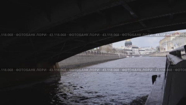 A pleasure excursion boat passes along the Moika River under the Kiss Bridge. View from the port side. Russia. St. Petersburg. 05/08/2024. Редакционное видео, видеограф Ярославский Максим / Фотобанк Лори