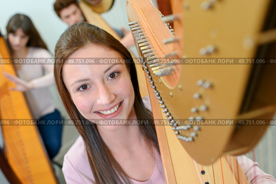 a portrait of female harpist. Стоковое фото, агентство Ingram Publishing / Фотобанк Лори
