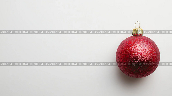 A red Christmas ball on a white background. New Year's Eve. This is a close-up of a free-standing red ball, free space for text. Стоковое AI-изображение, AI-художник Елена Зубкова / Фотобанк Лори