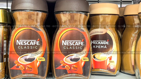 A row of coffee jars with the brand names Nescafe Classic and Nescafe. Russia. Moscow. 02.08.25. Редакционное фото, фотограф Ярославский Максим / Фотобанк Лори