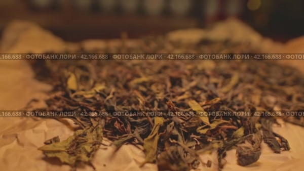 A scattering of dried tea lying on brown parchment. Стоковое видео, видеограф Даниил Хабаров / Фотобанк Лори