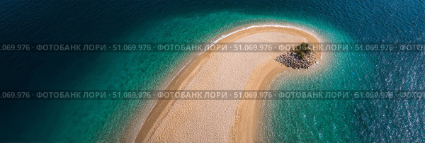 A stunning aerial view of a narrow sandy beach forming a crescent shape, surrounded by vibrant turquoise water. At the tip of the sandbar, a small patch of greenery with palm trees adds a serene tropical touch. The contrast between the golden sand and deep blue ocean creates a visually captivating and peaceful island paradise atmosphere. Стоковое AI-изображение, AI-художник Ксения Чунаева / Фотобанк Лори